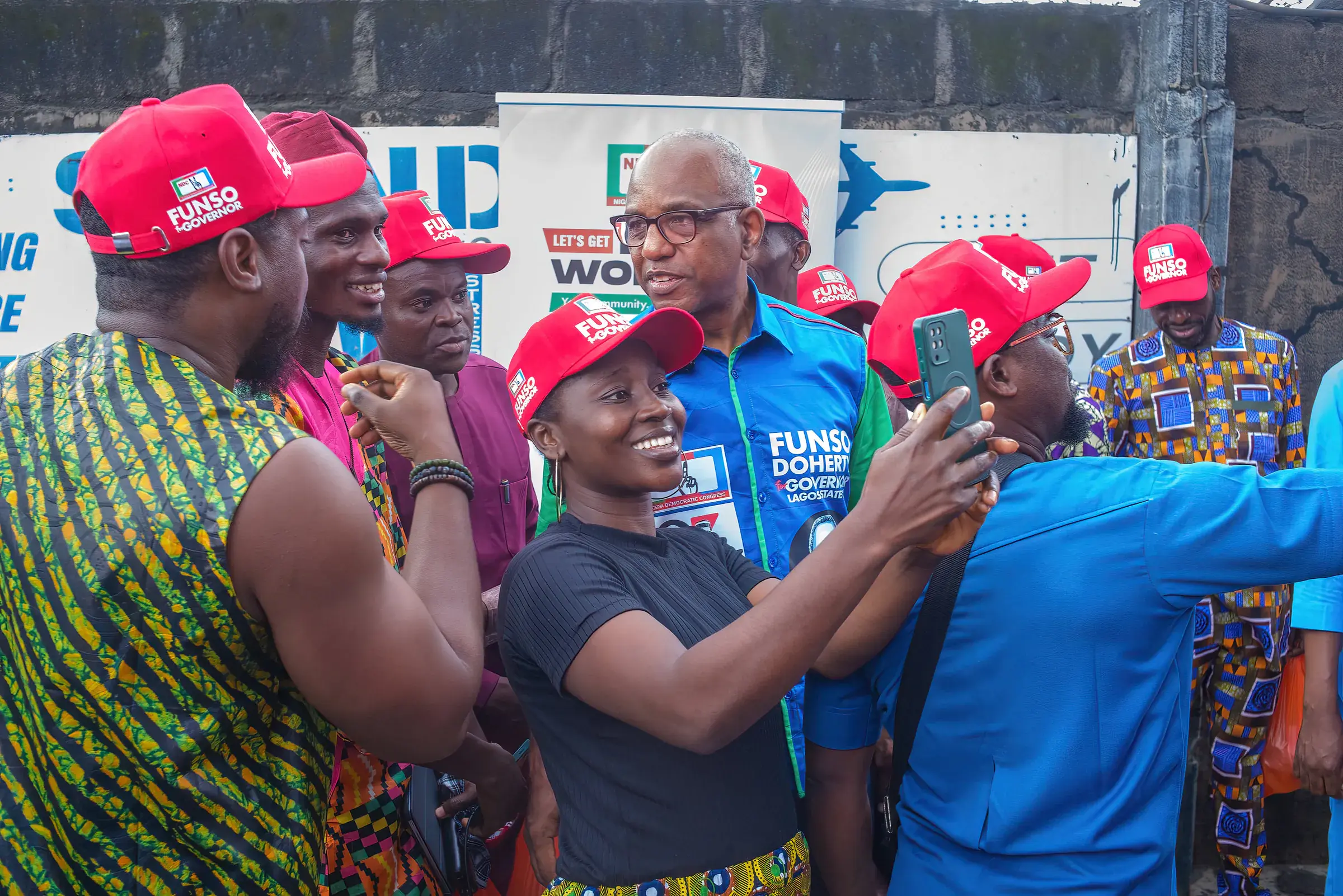 Funso Doherty with people during his visit to Alimosho.