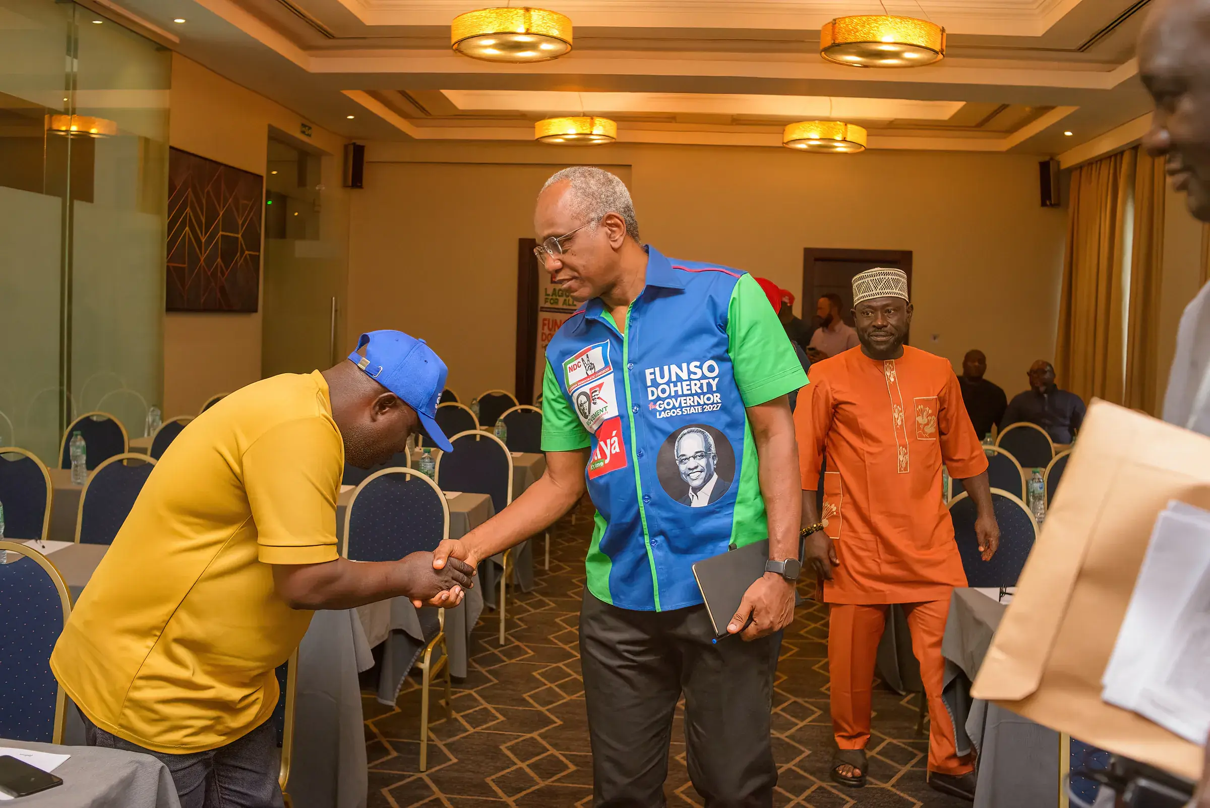 Funso Doherty with people at a meeting with NDC candidates.